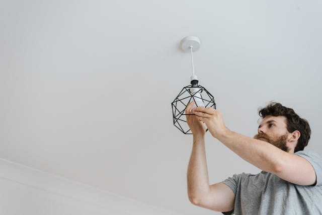 Person installing lightbulb